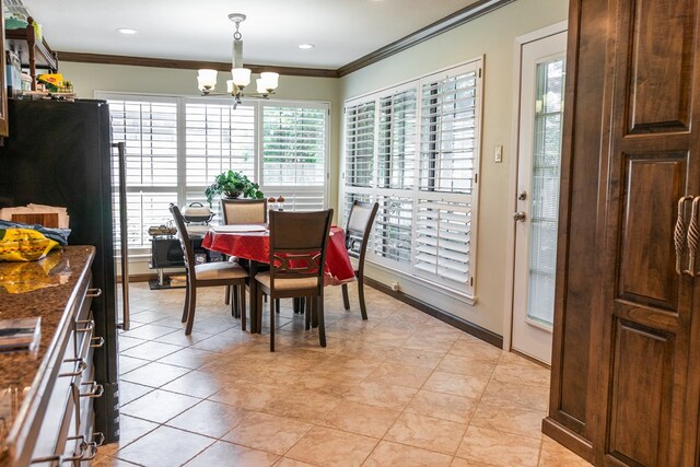 5213 Green Valley Trl, San Angelo, TX 76904 - dining room featuring crown molding, a chandelier, and light tile patterned flooring