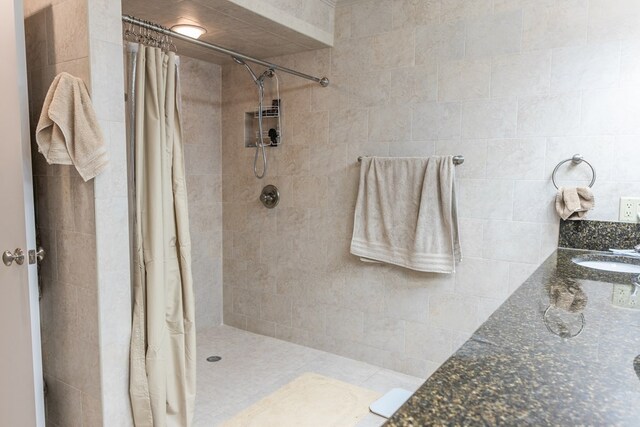 5213 Green Valley Trl, San Angelo, TX 76904 - bathroom with a tile shower and double vanity