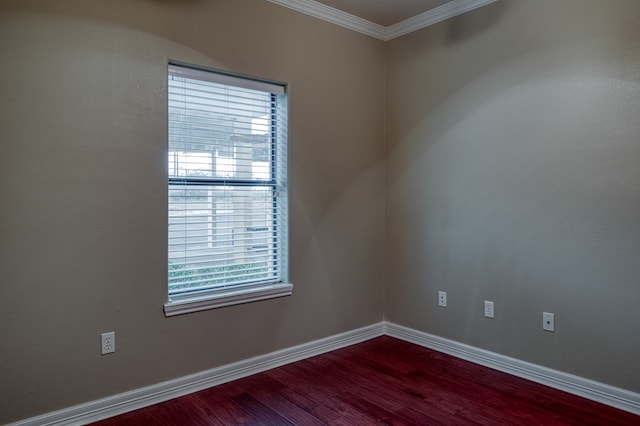 spare room featuring hardwood / wood-style floors and ornamental molding