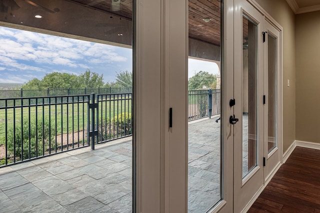 doorway to outside with crown molding