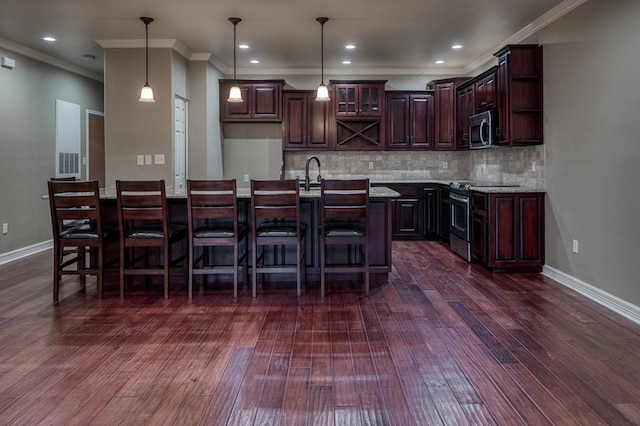 kitchen with appliances with stainless steel finishes, dark brown cabinetry, tasteful backsplash, ornamental molding, and decorative light fixtures