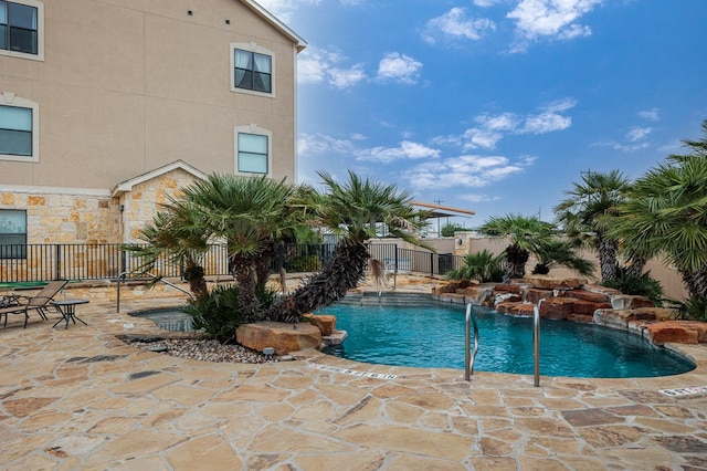 view of pool featuring pool water feature and a patio area