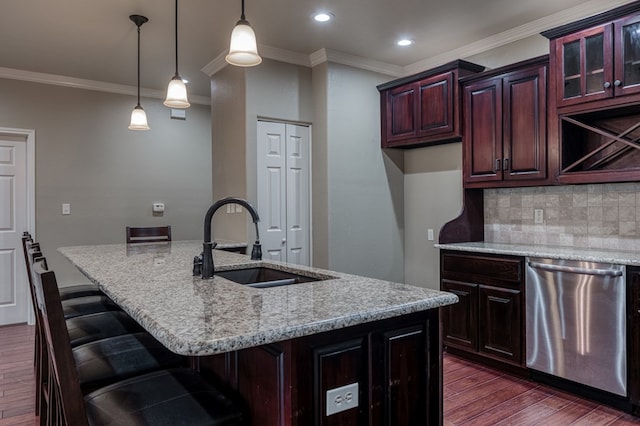 kitchen with dishwasher, sink, an island with sink, and decorative light fixtures