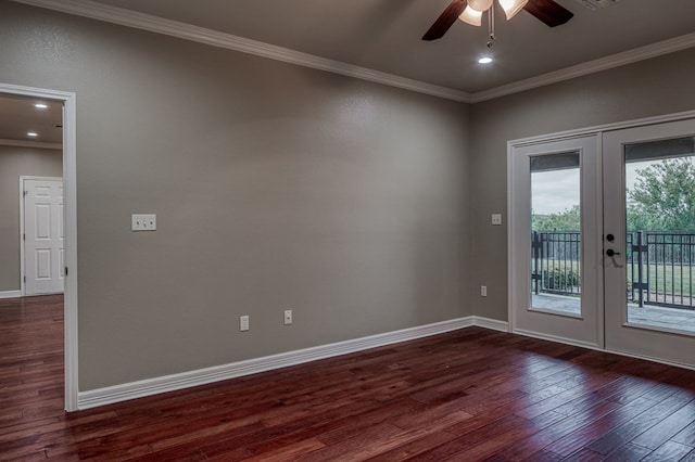 spare room featuring dark hardwood / wood-style floors, ornamental molding, and french doors