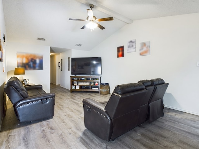 living room featuring hardwood / wood-style flooring, ceiling fan, and lofted ceiling with beams