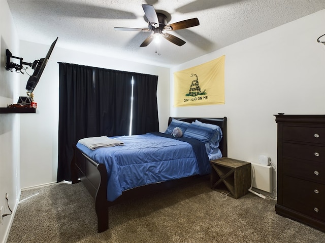 bedroom with ceiling fan, carpet flooring, and a textured ceiling