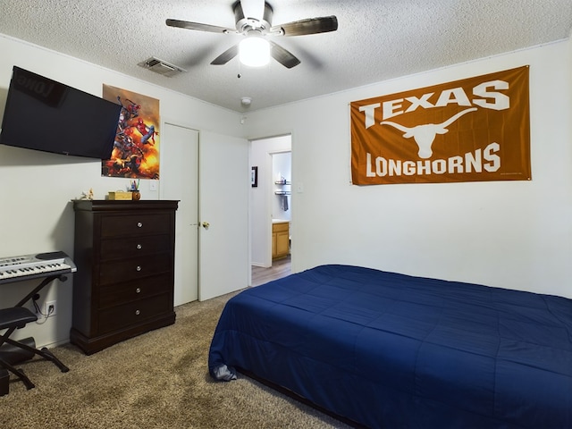 bedroom with ceiling fan, carpet flooring, and a textured ceiling