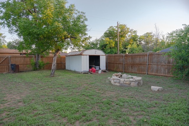 417 E 47th St, San Angelo, TX 76903 - fenced backyard featuring a storage unit and a fire pit