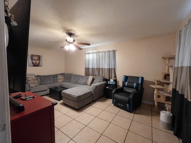 417 E 47th St, San Angelo, TX 76903 - living room featuring light tile patterned flooring, a ceiling fan, and a textured ceiling