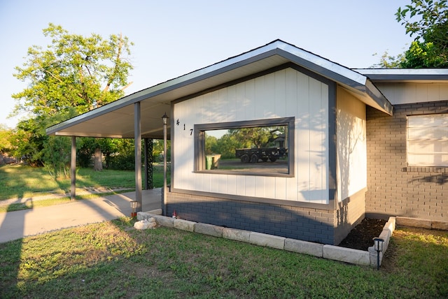 417 E 47th St, San Angelo, TX 76903 - view of property exterior with brick siding and a lawn