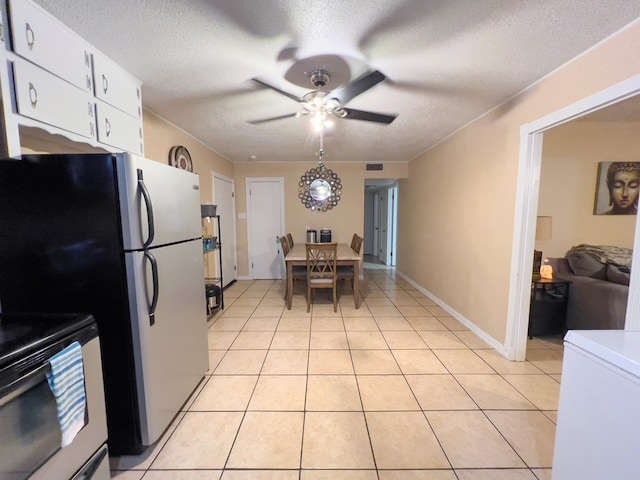 417 E 47th St, San Angelo, TX 76903 - dining space with ceiling fan, light tile patterned floors, and a textured ceiling