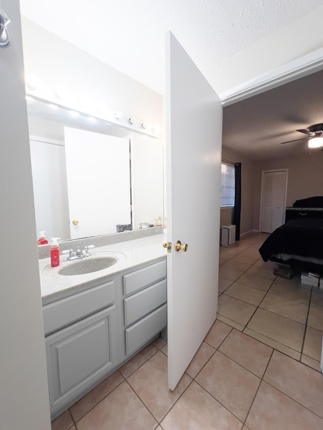 417 E 47th St, San Angelo, TX 76903 - bathroom featuring tile patterned floors, vanity, and a textured ceiling