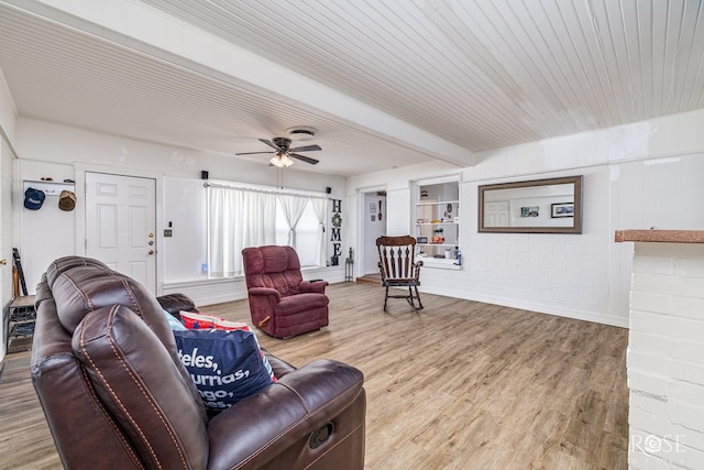 2822 N St, San Angelo, TX 76901 - living area with beamed ceiling, wood finished floors, ceiling fan, and brick wall