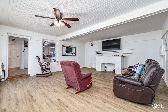 2822 N St, San Angelo, TX 76901 - living room featuring a ceiling fan, wood finished floors, and a brick fireplace