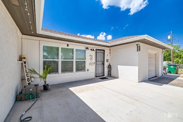 2822 N St, San Angelo, TX 76901 - view of front of home featuring an attached garage, brick siding, and driveway