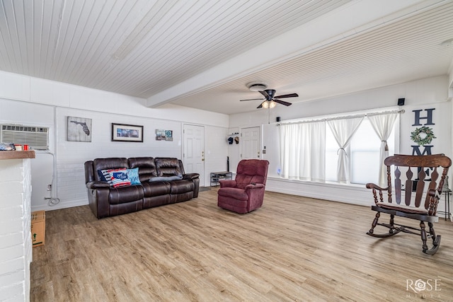 2822 N St, San Angelo, TX 76901 - living room featuring an AC wall unit, wood finished floors, a ceiling fan, and beam ceiling