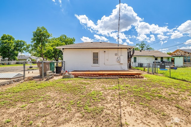 2822 N St, San Angelo, TX 76901 - back of property featuring a fenced backyard, a deck, and brick siding