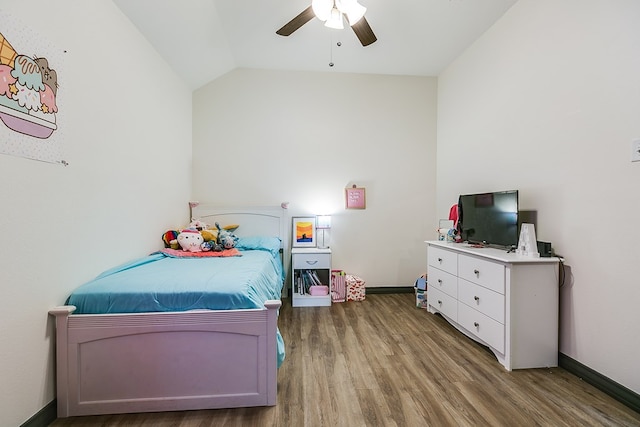 bedroom with ceiling fan, vaulted ceiling, baseboards, and wood finished floors