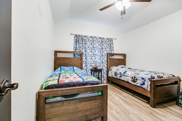 bedroom featuring vaulted ceiling, ceiling fan, and wood finished floors