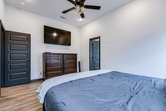 bedroom with light wood-style floors, ceiling fan, and visible vents