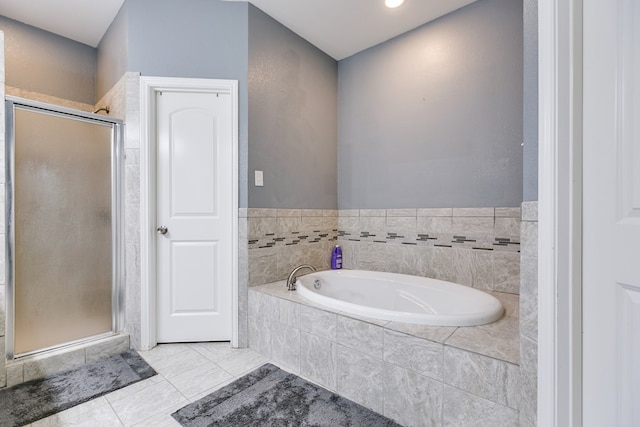 full bathroom featuring a bath and a stall shower