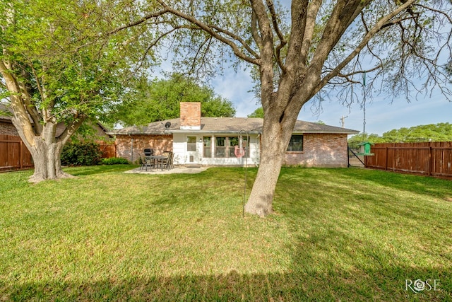 201 Hudspeth St, Sonora, TX 76950 - back of property featuring a patio, a lawn, a fenced backyard, and a chimney