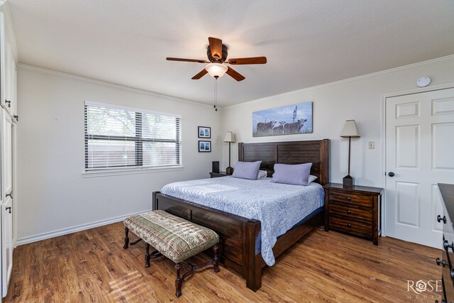 201 Hudspeth St, Sonora, TX 76950 - bedroom featuring baseboards, wood finished floors, ceiling fan, and ornamental molding
