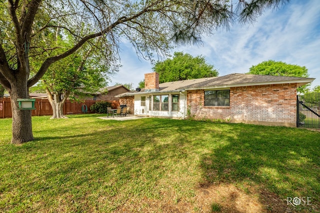 201 Hudspeth St, Sonora, TX 76950 - rear view of house with a chimney, brick siding, a patio, and a fenced backyard