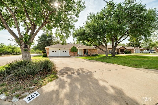 201 Hudspeth St, Sonora, TX 76950 - single story home with a front yard, driveway, and an attached garage