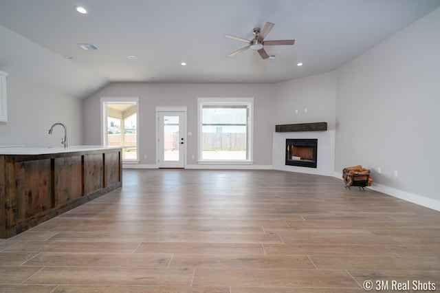 5201 Royal Oak Dr, San Angelo, TX 76904 - unfurnished living room featuring a tile fireplace, recessed lighting, light wood-type flooring, lofted ceiling, and ceiling fan
