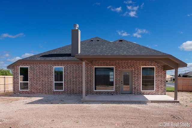 5201 Royal Oak Dr, San Angelo, TX 76904 - rear view of property with a shingled roof, brick siding, a patio area, and a chimney