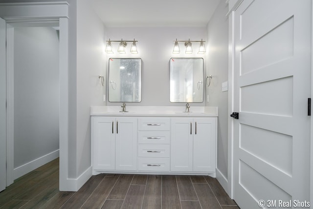 5201 Royal Oak Dr, San Angelo, TX 76904 - bathroom with wood finished floors and double vanity