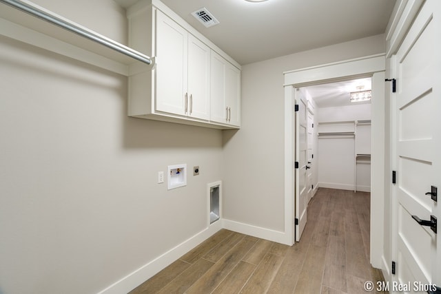5201 Royal Oak Dr, San Angelo, TX 76904 - laundry room with hookup for an electric dryer, light wood-type flooring, washer hookup, and cabinet space