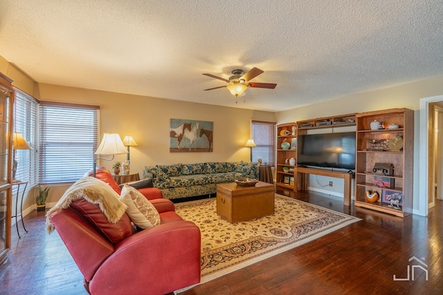 living area featuring baseboards, a textured ceiling, a ceiling fan, and wood finished floors