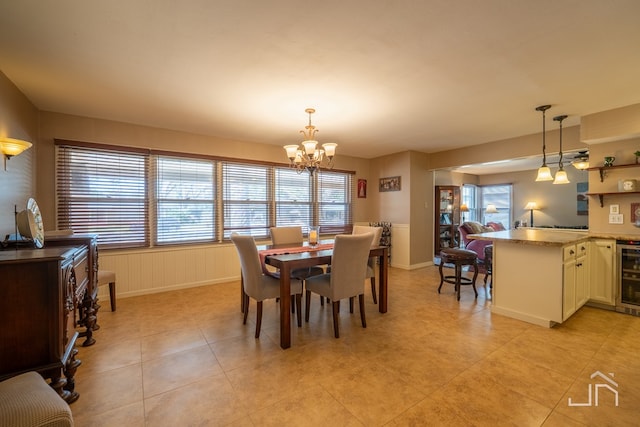 dining space with an inviting chandelier, wine cooler, and light tile patterned floors