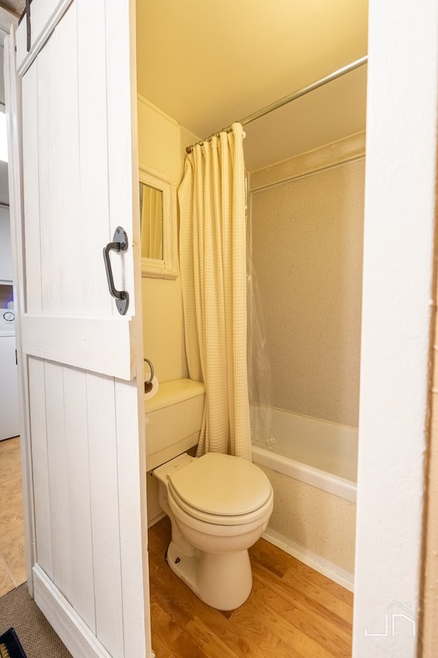 full bath with toilet, shower / bath combo, and wood finished floors