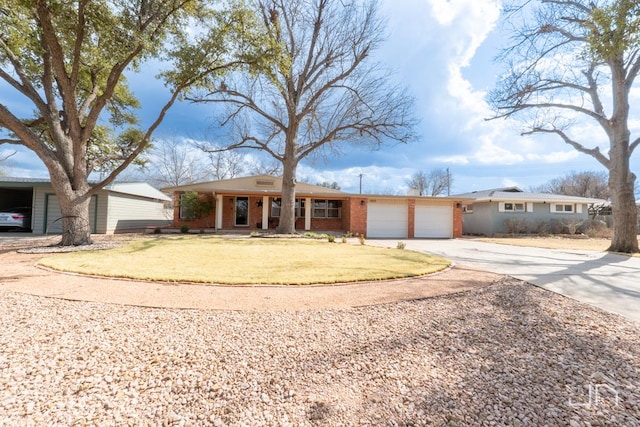 single story home featuring concrete driveway, brick siding, a front lawn, and an attached garage