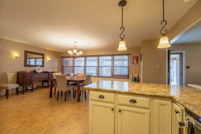 kitchen with light tile patterned floors, a chandelier, light stone countertops, and pendant lighting