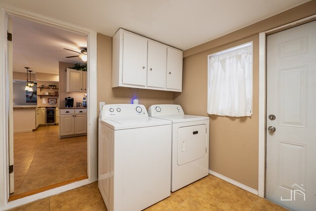 laundry area featuring cabinet space, baseboards, a ceiling fan, wine cooler, and washing machine and clothes dryer