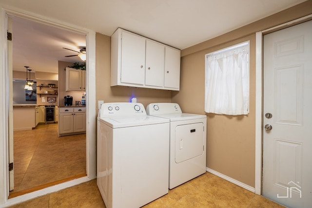 laundry area with cabinet space, baseboards, a ceiling fan, wine cooler, and separate washer and dryer