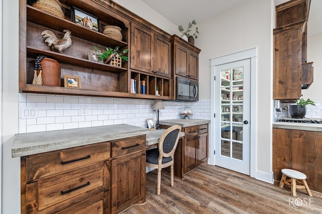 home office featuring dark hardwood / wood-style floors and built in desk