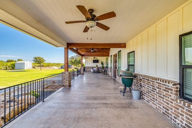 view of patio / terrace featuring a storage shed and ceiling fan