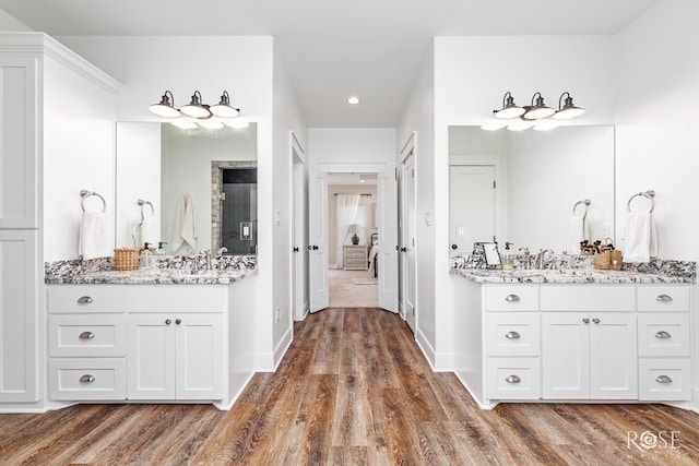 bathroom with hardwood / wood-style flooring and vanity