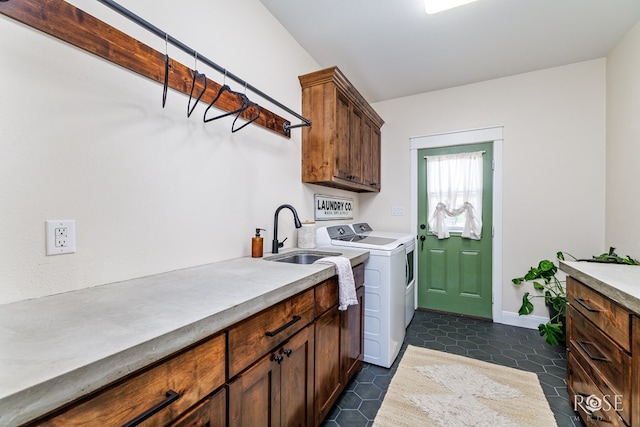 washroom featuring washer and dryer, sink, cabinets, and dark tile patterned floors