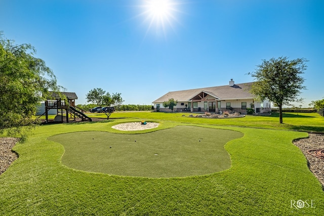 view of property's community featuring a yard and a playground