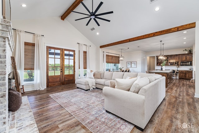 living room featuring french doors, dark hardwood / wood-style floors, high vaulted ceiling, and beam ceiling