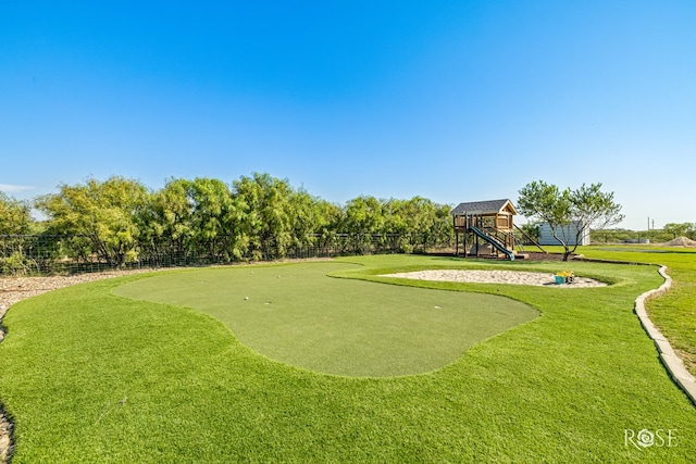 surrounding community with a yard and a playground