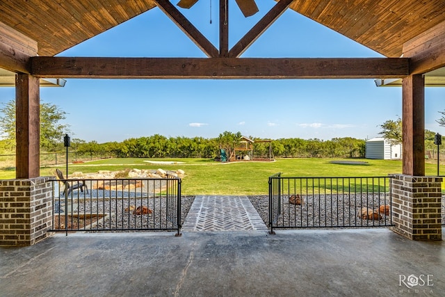 exterior space featuring a shed, a lawn, and a patio