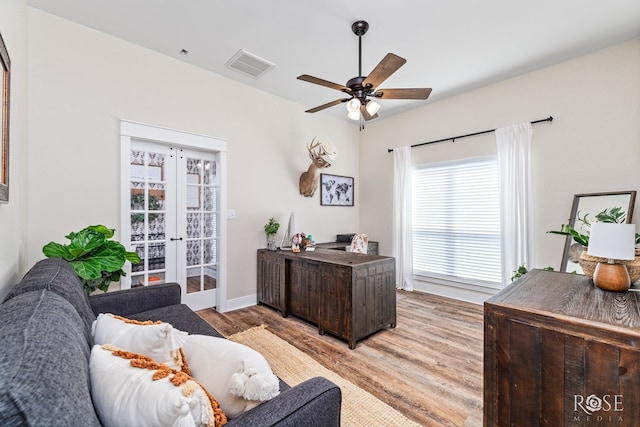 office featuring french doors, ceiling fan, and light hardwood / wood-style flooring