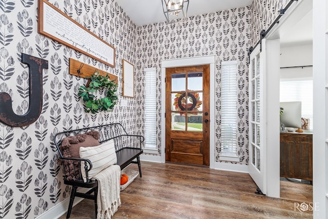 foyer featuring a barn door and hardwood / wood-style floors